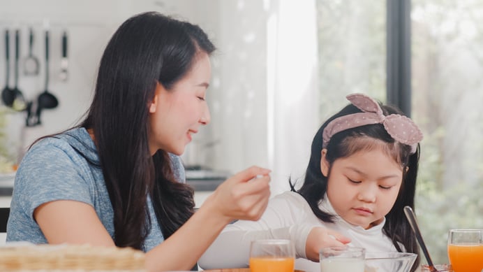 asian-japanese-family-has-breakfast-home-asian-mom-daughter-happy-talking-together-while-eating-bread-drink-orange-juice-corn-flakes-cereal-milk-table-modern-kitchen-morning