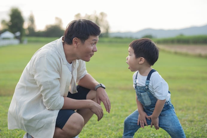 father-son-playing-park-sunset-time-people-having-fun-field-concept-friendly-family-summer-vacation-father-son-legs-walk-across-lawn-park